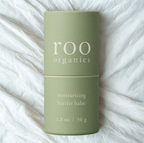 Green cylindrical container of Roo Organics Moisturizing Barrier Balm for pediatric skincare, designed to soothe and protect sensitive baby skin and treat eczema.