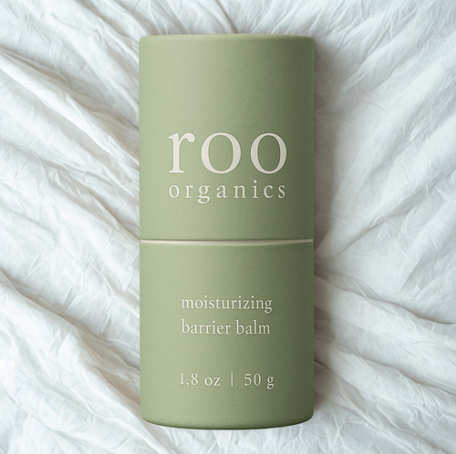 Green cylindrical container of Roo Organics Moisturizing Barrier Balm for pediatric skincare, designed to soothe and protect sensitive baby skin and treat eczema.
